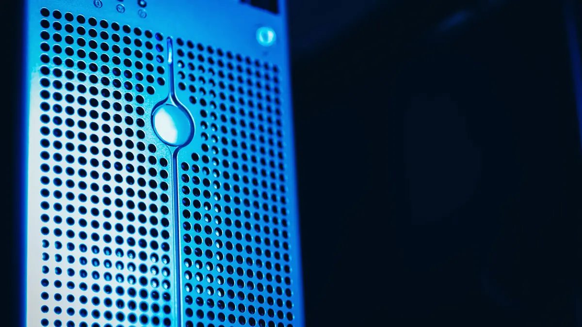 Front panel of a server lit in blue in a data center